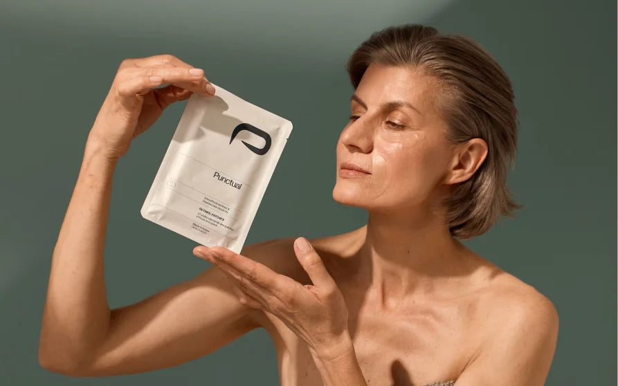 Woman holding Punctual skincare packaging